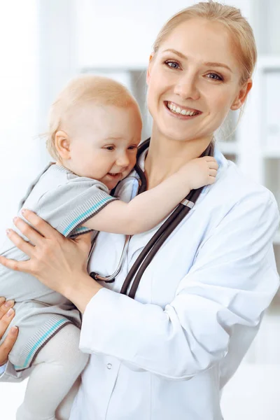 Doctor and patient in hospital. Little girl is being examined by doctor with stethoscope. Medicine concept Stock Image