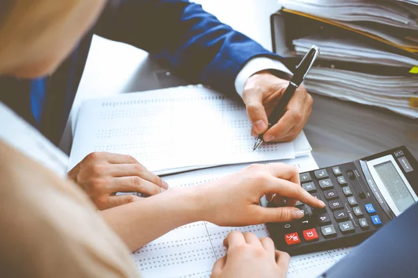 Bookkeeper or financial inspector and secretary making report, calculating or checking balance. Internal Revenue Service inspector checking financial document. Business, tax and audit concepts — Stock Photo, Image