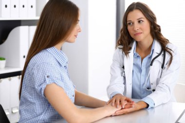 Doktor, kadın hastasına güvence veriyor. Tıp etiği ve güven kavramı. İlaç ve sağlık hizmeti teması