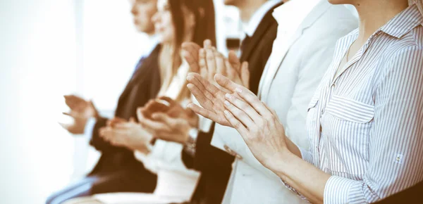 Business people clapping and applause at meeting or conference, close-up of hands. Group of unknown businessmen and women in modern white office. Success teamwork or corporate coaching concept — Stock Photo, Image