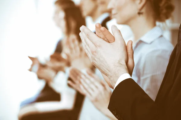 Business people clapping and applause at meeting or conference, close-up of hands. Group of unknown businessmen and women in modern white office. Success teamwork or corporate coaching concept — Stock Photo, Image