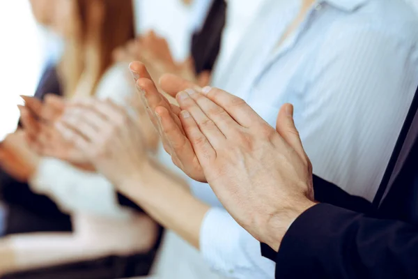 Pessoas de negócios aplaudindo e aplaudindo em reunião ou conferência, close-up de mãos. Grupo de homens de negócios e mulheres desconhecidos no escritório branco moderno. Trabalho em equipe de sucesso ou conceito de coaching corporativo — Fotografia de Stock