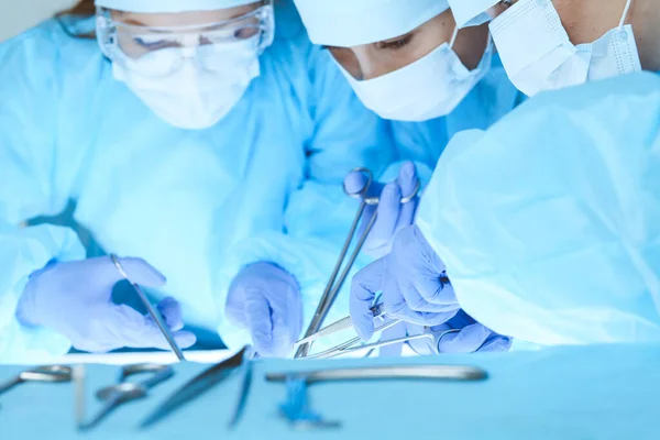 Close-up of medical team performing operation. Group of surgeons at work are busy of patient. Medicine, veterinary or healthcare and emergency in hospital — Stock Photo, Image