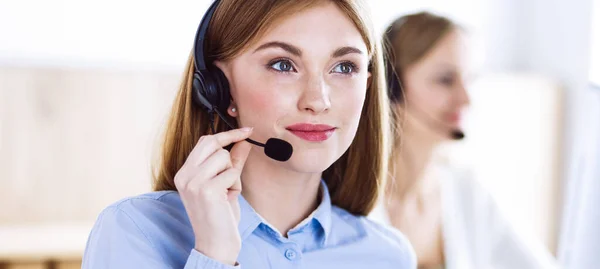 Portrait of call center operator at work. Group of people in a headset ready to help customers. Business concept Royalty Free Stock Images