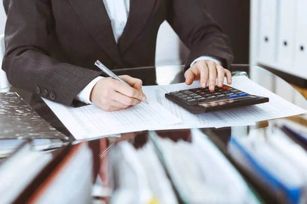 Bookkeeper woman or financial inspector making report, calculating or checking balance, close-up. Business, audit or tax concepts — Stock Photo, Image