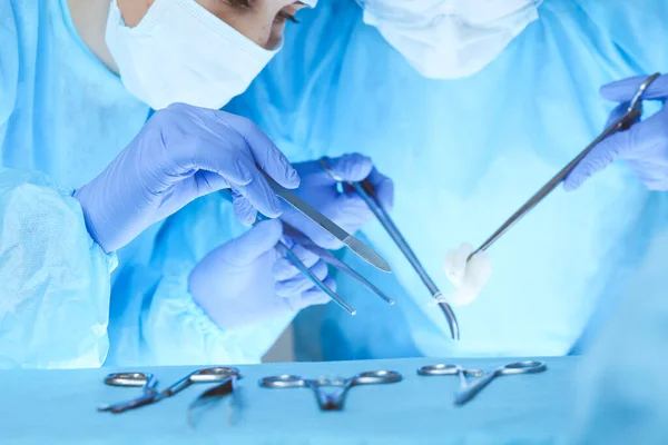 Close-up of medical team performing operation. Group of surgeons at work are busy of patient. Medicine, veterinary or healthcare and emergency in hospital — Stock Photo, Image