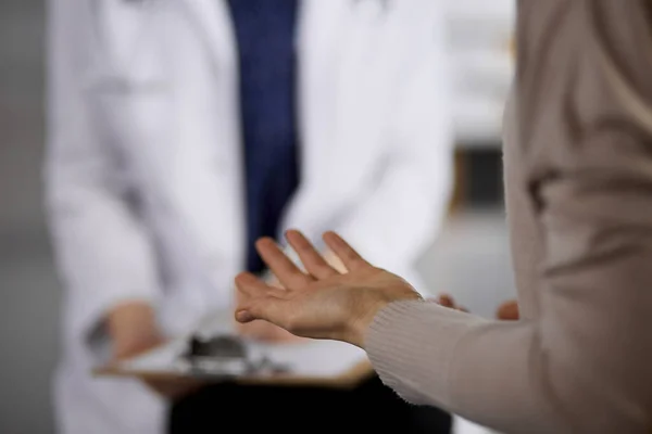 Doctor and patient discussing current health examination while sitting in clinic. Perfect medical service in hospital. Medicine concept — Stock Photo, Image