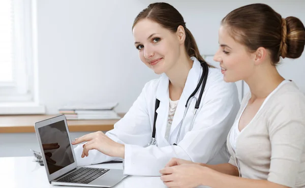 Orvos és beteg ül, és megvitassák az egészségügyi vizsgálati eredmények használata közben laptop számítógép. Egészségügy, orvostudomány és jó hírek — Stock Fotó