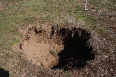 Terelle, Italy - March 15, 2009: The small sinkhole in the Terelle countryside in the province of Frosinone clipart