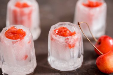 Taze kiraz kokteyl. Taze yaz kokteyl kiraz ve buz küpleri ile. Bardak vişne soda içecek karanlık taş zemin üzerine