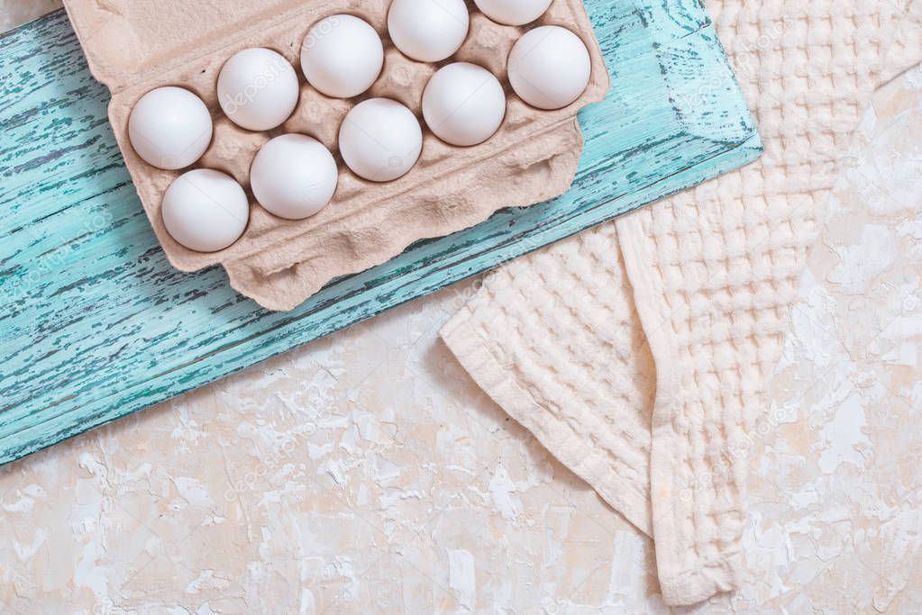 Mix of chicken egg and duck egg put on paper tray, on blue wooden vintage background. linen cloth. cooking food. flait lay