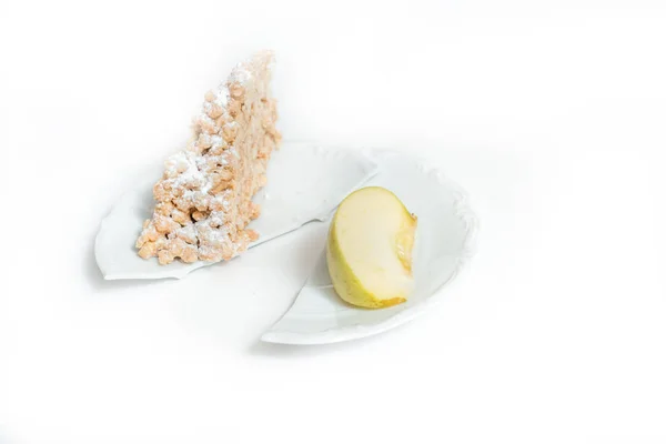 apple vs cupcake - snack decision between healthy food or junk food Broken plate. Concept of choice, diet and weight loss.
