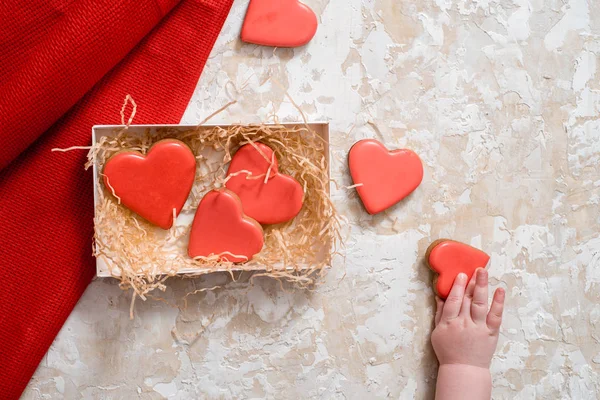 Homemade gingerbread with letters love for Valentines Day located on a dark background, top view