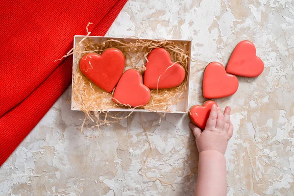 Homemade gingerbread with letters love for Valentines Day located on a dark background, top view