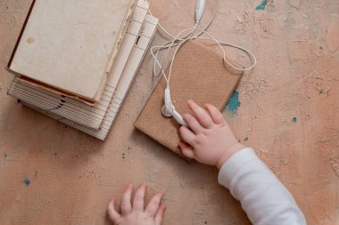 Sesli kitap kavramı. Kulaklıklar, kahve ve ahşap masa kitap. Metin alanı olan Üstten Görünüm