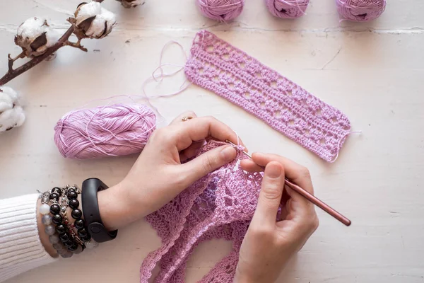Petals purple crochet flower and wood crochet needles.