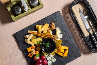 Peynir tabağı ile peynir ürün çeşitliliği, incir, bal ve fındık gri beton arka plan, üstten görünüm üzerinde düz-lay. Parti veya toplama beslenme kavramı