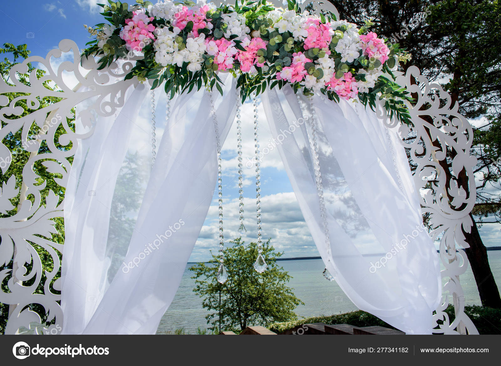 White arch with white and pink flowers outdoors .festive decor for the    of the wedding ceremony outdoors. Stock  Photo by ©Irishasel 277341182
