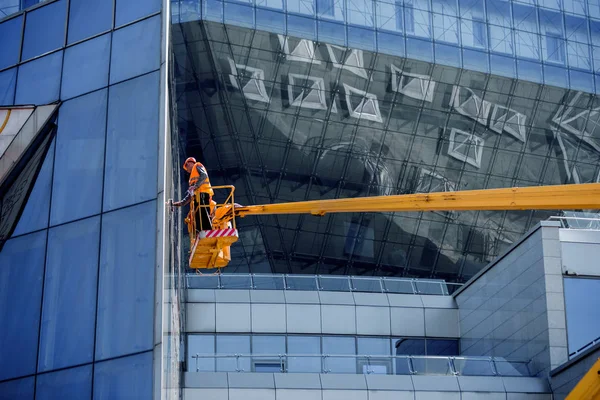 A Team Of Climbing Workers Clean the Windows on Skyscraper
