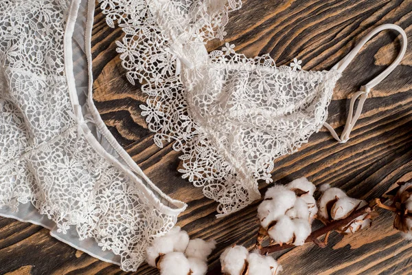 Pamuk çizgili külot ve beyaz sütyen. Beton arka planda kadın iç çamaşırı. Moda kadın iç çamaşırı üst görünümü. Doğal yumuşak kumaş