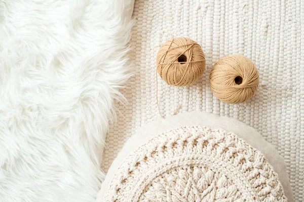 Threads, crocheted round napkin. White napkin like a flower. on a fur white background and knitted light background. Balls of thread in a wicker box.cozy home and handmade concept — Stock Photo, Image