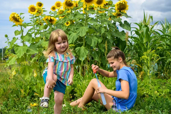 Two Smiling Happy Children Sunflowers Field Laugh Blow Bubbles Summer — Stock Photo, Image