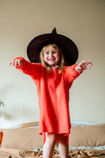 Little Girl Witch Hat Orange Ball Her Hand Yellow Background — Stock Photo, Image