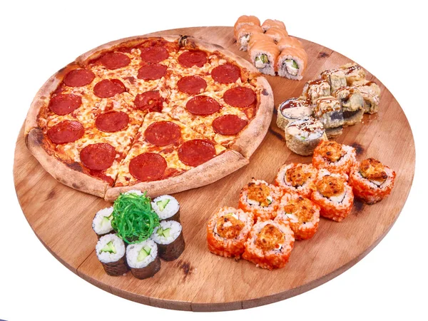 Pepperoni pizza with sushi rolls set on wood isolated