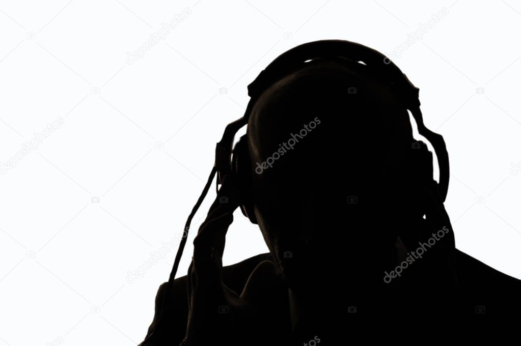 The secret agent in the contour light overhears the conversation, listening to the sound in the headphones