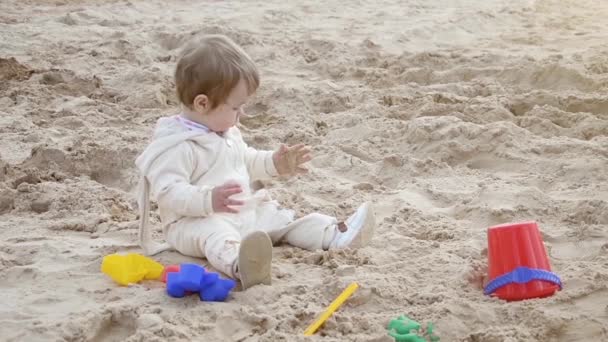 おもちゃで砂の中で遊ぶビーチの女の子 — ストック動画
