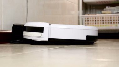 Robot elektrikli süpürge şarj cihazının tabanından aşağı doğru hareket eder