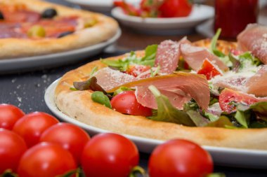 Et ve otlar ile Pizza, peynir, kiraz domates serpilir