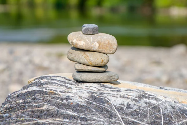 The stones are stacked on top of each other against the background of nature