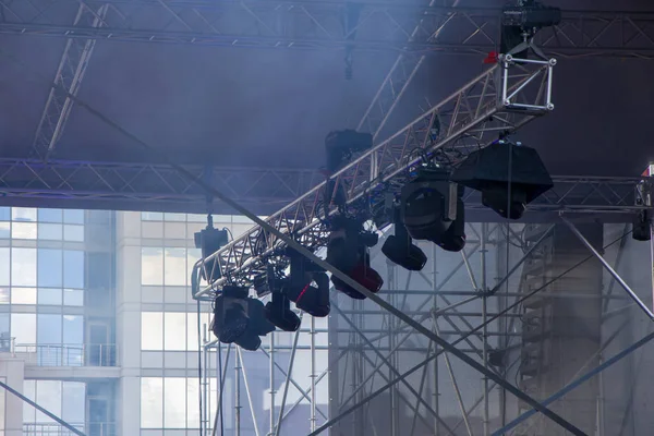 A light ramp suspended above the stage with floodlights and lighting fixtures, concert venues and equipment