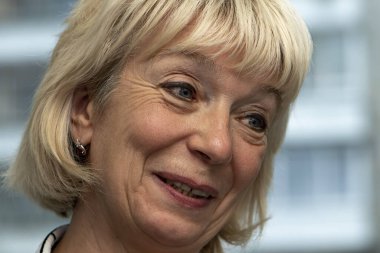 Tarafsız bir arkaplanda gülümseyen yaşlı bir kadının portresi, yakın plan. Belki de yaşlı bir müzik öğretmenidir. Torunlarına bakan emekli bir büyükanne..