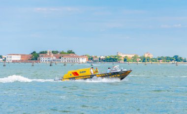A medical ambulance boat with the word Ambulanza written on it sails along a Venetian canal Italy, Venice, 11 July 2025
