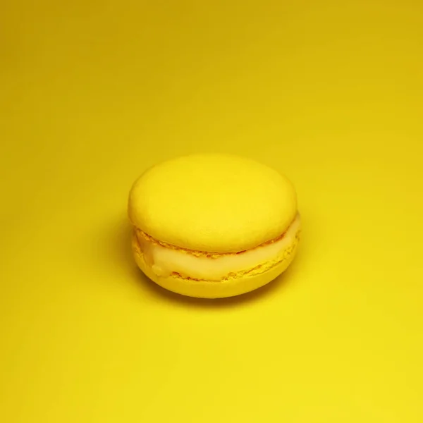 Yellow macaroon cake on yellow background bright food photography