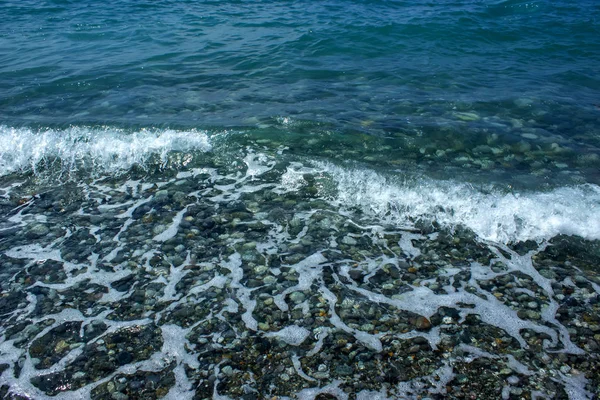 Piedras marinas y olas en la playa. Fondo de verano . — Foto de Stock