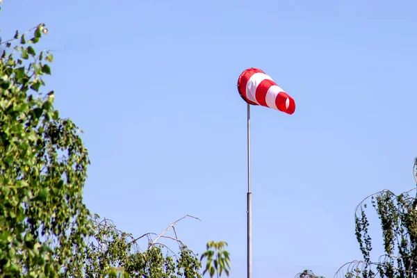 Windsock indicating wind on blue sky background. — Stock Photo, Image