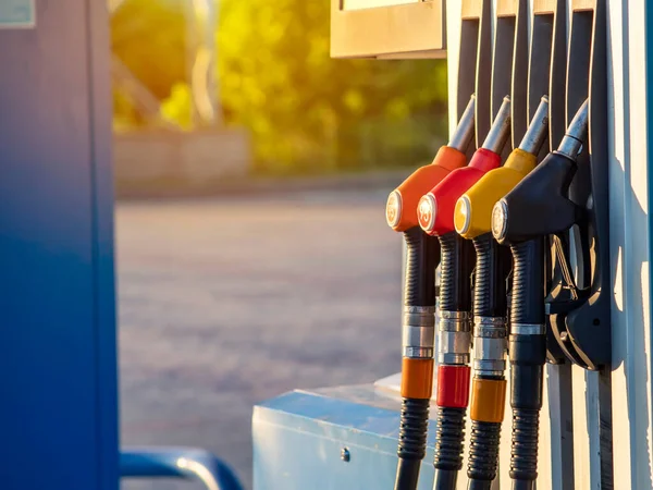 Gas station and filling guns for tank cars with different type of gasoline, rising fuel prices