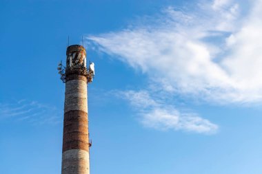 Telekomünikasyon antenleri eski bir tuğla bacada. Sanayi konsepti. Modern teknoloji. Baz istasyonu