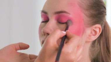 Gözleri renkli kaptırdın yaratıcı makyaj eğitimi yapma, makro yakın çekim. Bir güzel model kızlar yüz güzellik sınıfı, yaratıcı maquillage uygulama makyaj sanatçısı.