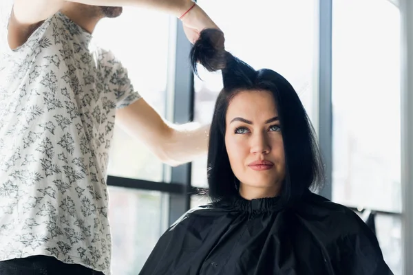 Невпізнаваний перукар створює зачіску для красивої брюнетки — стокове фото