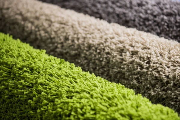 Set of three different colorful artificial shaggy carpets. — Stock Photo, Image