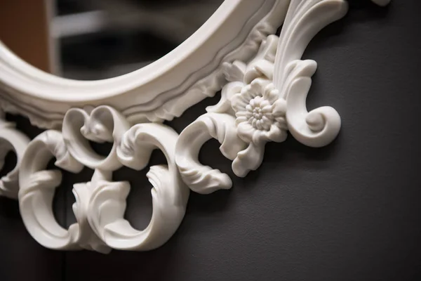 Expensive interior. Stucco elements on a mirror. White patterned. Mouldings element from gypsum or plastic. Roccoco style — Stock Photo, Image