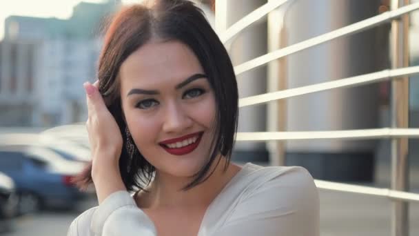 Close up portrait of beautiful young woman smiling hair blowing in wind outdoors slow motion — Stock Video