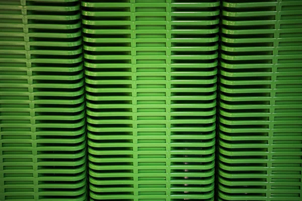 Green plastic home containers tower at store