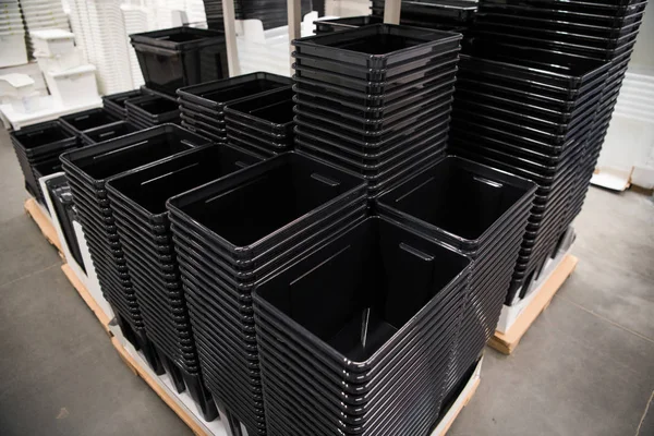 Conteneurs en plastique noir empilés dans un magasin — Photo