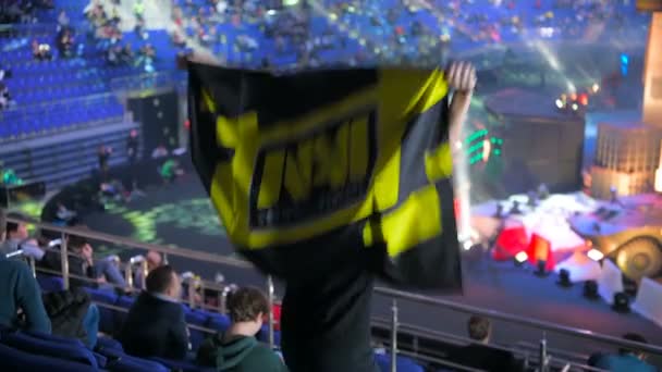 MOSCOW, RUSSIA - OCTOBER 27 2018: EPICENTER Counter Strike: Global Offensive esports event. Happy beautiful girl fan at arena with team Natus Vincere NaVi flag. Cheering, looking at camera and smiling — Stock Video