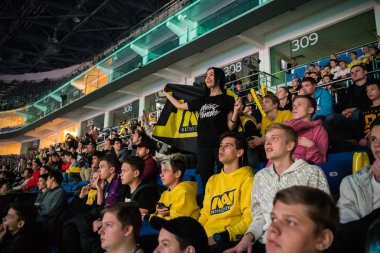 Moskova, Rusya - 27 Ekim 2018: Merkez üssü Counter Strike: küresel saldırgan esports olay. Mutlu kız Arena ekibi Natus Vincere bayrağı ile bir tribün fan. Onun favori takımı için tezahürat.